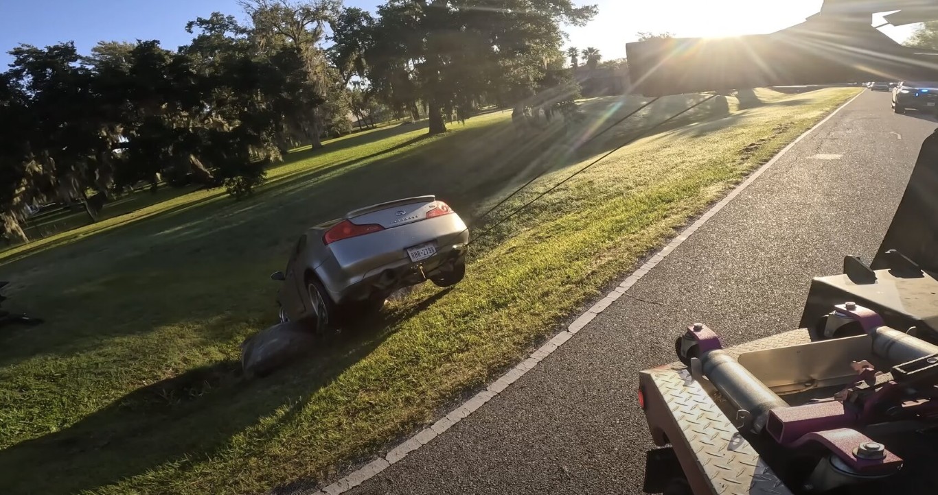 Professional roadside assistance technician helping a stranded motorist on the roadside in Pembroke Pines, FL