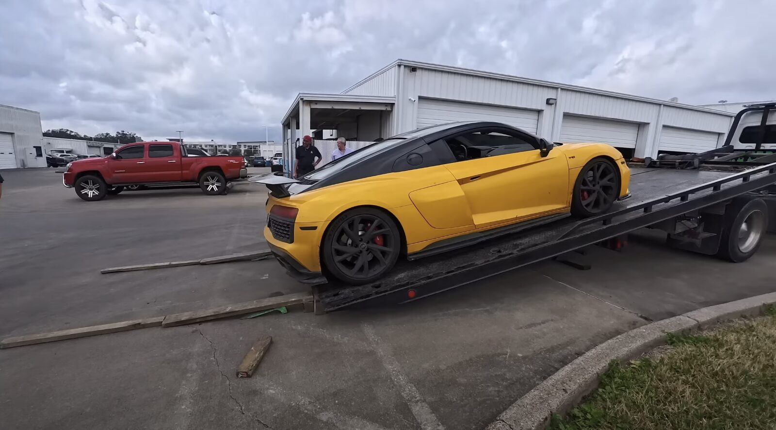Professional luxury vehicle towing on flatbed truck